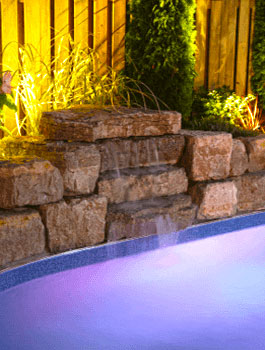 landscape accent lighting landscape construction black diamond lights near fence and stone wall with pool fountain water